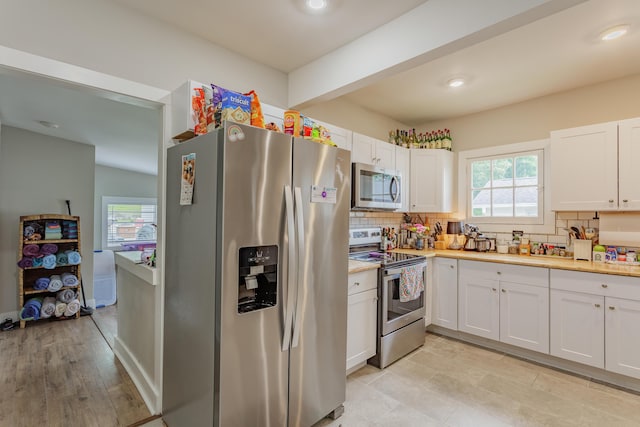 109 Sequoia Dr, Chattanooga, TN 37411 - kitchen with appliances with stainless steel finishes, healthy amount of natural light, tasteful backsplash, white cabinets, and recessed lighting