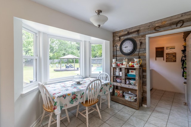 9505 Post Oak Dr, Ooltewah, TN 37363 - dining space featuring baseboards, light tile patterned floors, and an accent wall