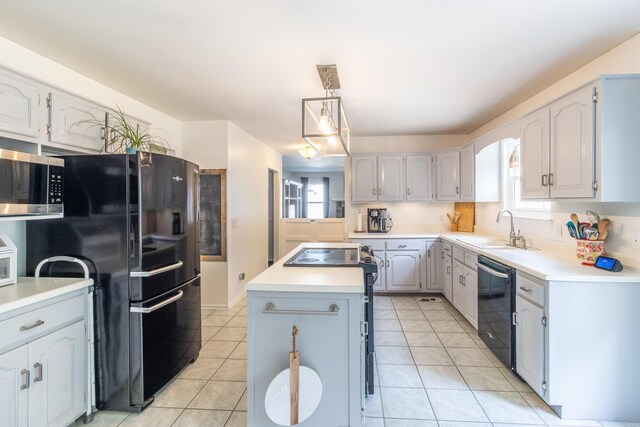 9505 Post Oak Dr, Ooltewah, TN 37363 - kitchen featuring a sink, light tile patterned flooring, a kitchen island, and black appliances
