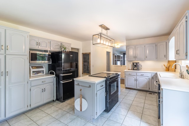 9505 Post Oak Dr, Ooltewah, TN 37363 - kitchen with a center island, light countertops, a sink, light tile patterned floors, and black appliances