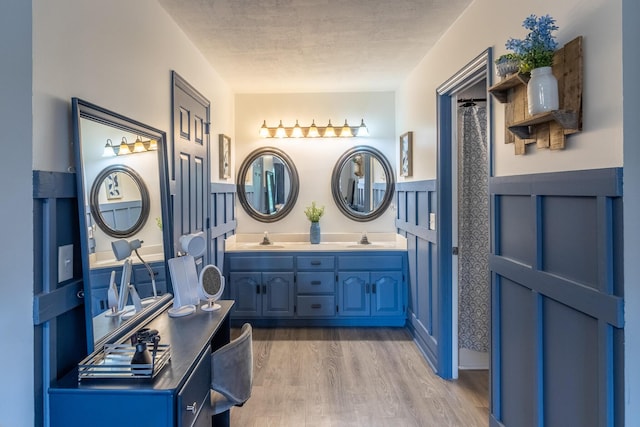 9505 Post Oak Dr, Ooltewah, TN 37363 - full bath with double vanity, a sink, a textured ceiling, and wood finished floors