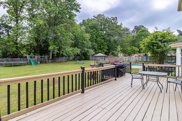 9505 Post Oak Dr, Ooltewah, TN 37363 - deck featuring a trampoline, a fenced in pool, a fenced backyard, a playground, and a yard