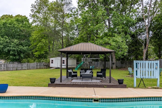 9505 Post Oak Dr, Ooltewah, TN 37363 - view of pool featuring a wooden deck, a fenced backyard, a storage unit, a gazebo, and an outbuilding