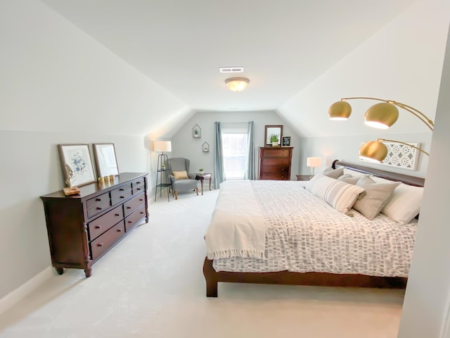 carpeted bedroom featuring visible vents and vaulted ceiling