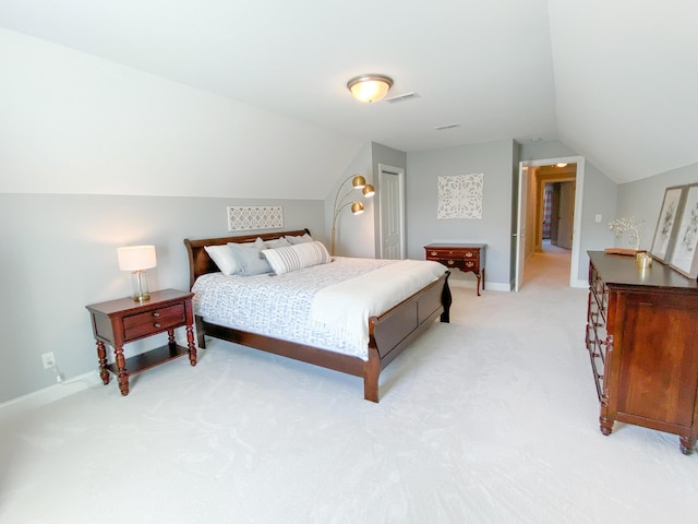 bedroom featuring baseboards, visible vents, light colored carpet, and lofted ceiling