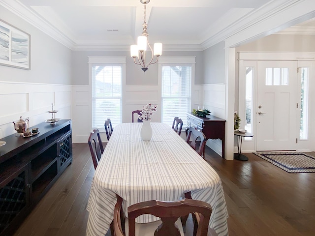 dining space featuring an inviting chandelier, dark wood-style floors, a wainscoted wall, and a decorative wall