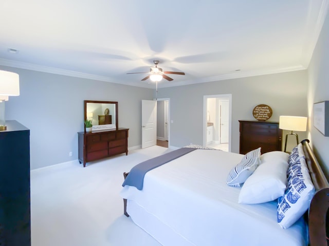 bedroom with a ceiling fan, ornamental molding, carpet, and ensuite bath