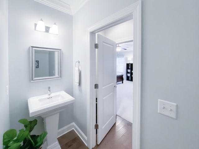bathroom with baseboards, ornamental molding, a ceiling fan, and wood finished floors