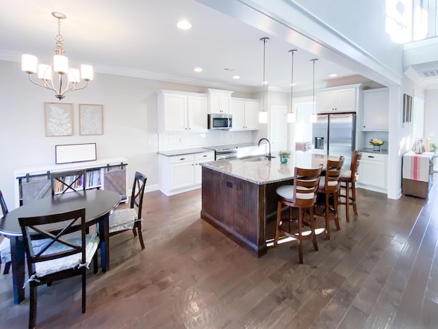 kitchen featuring crown molding, a sink, tasteful backsplash, and stainless steel appliances