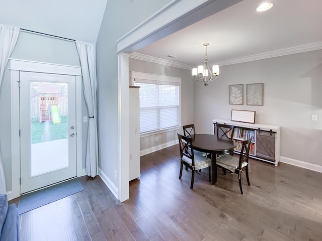 dining room featuring baseboards, a notable chandelier, ornamental molding, and dark wood finished floors