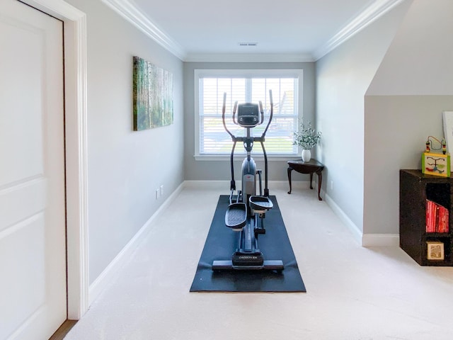 workout room featuring crown molding, carpet flooring, baseboards, and visible vents