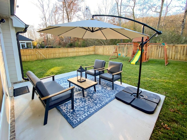 view of patio / terrace with outdoor lounge area, a fenced backyard, and a playground