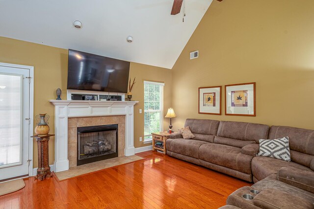 8337 Kayla Rose Cir, Ooltewah, TN 37363 - living room with wood finished floors, ceiling fan, a tile fireplace, and high vaulted ceiling