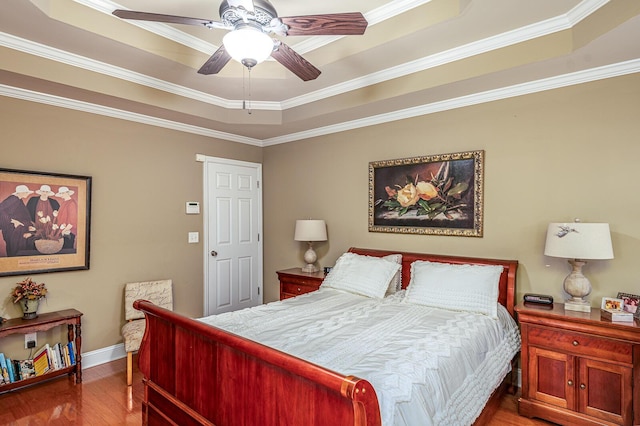 8337 Kayla Rose Cir, Ooltewah, TN 37363 - bedroom with a tray ceiling, wood finished floors, crown molding, and a ceiling fan