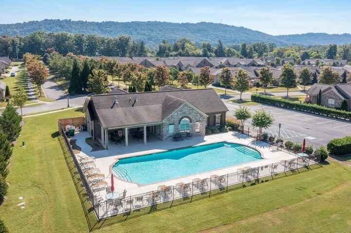 community pool featuring a patio area and fence