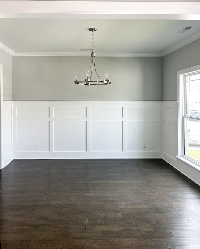 unfurnished dining area with ornamental molding, an inviting chandelier, visible vents, a decorative wall, and a wainscoted wall