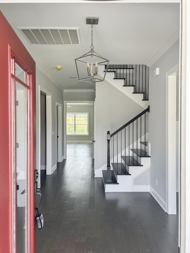 foyer featuring stairs, a notable chandelier, visible vents, and dark wood finished floors
