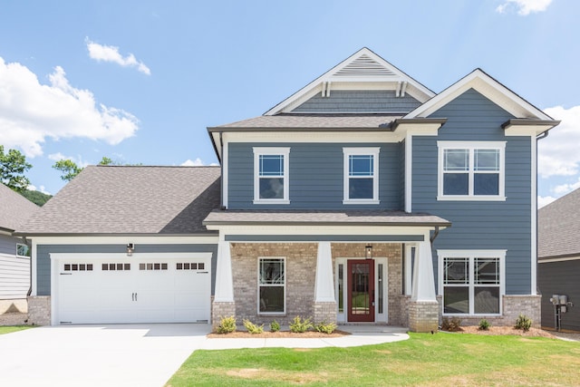 craftsman-style home featuring driveway, brick siding, a garage, a front yard, and roof with shingles