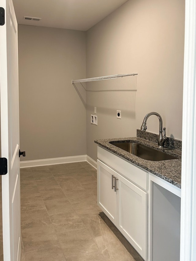 laundry area with a sink, visible vents, electric dryer hookup, baseboards, and hookup for a washing machine
