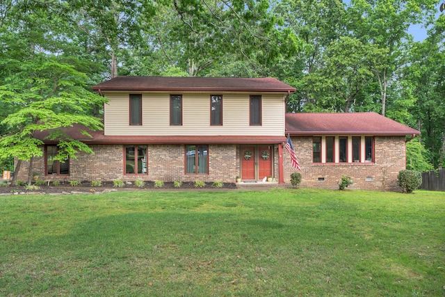 tri-level home with brick siding, crawl space, fence, and a front yard