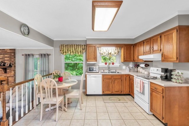 kitchen featuring crown molding, a sink, light countertops, under cabinet range hood, and white appliances