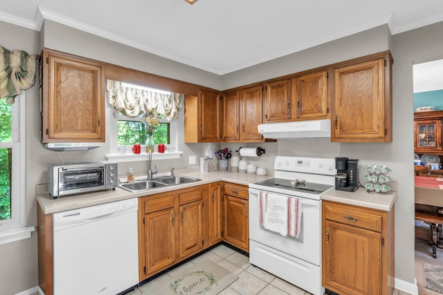 kitchen with a sink, white appliances, light countertops, a toaster, and under cabinet range hood