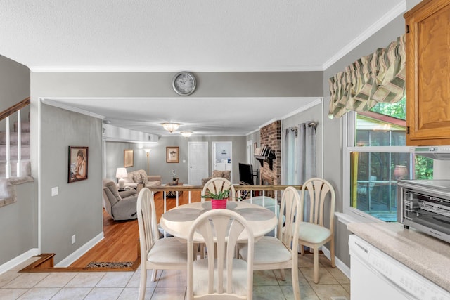 dining space with stairs, baseboards, ornamental molding, and light tile patterned floors