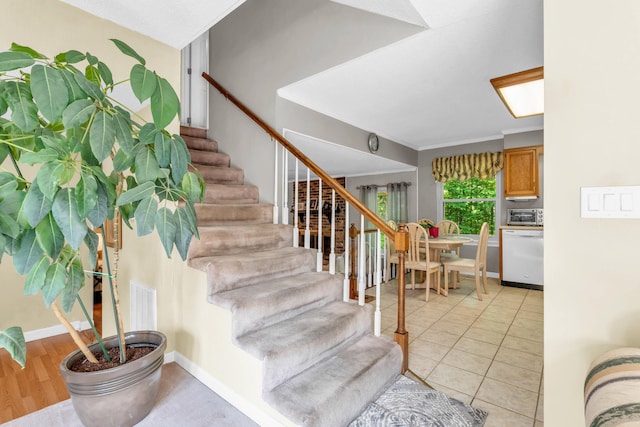 staircase featuring visible vents, baseboards, and a toaster