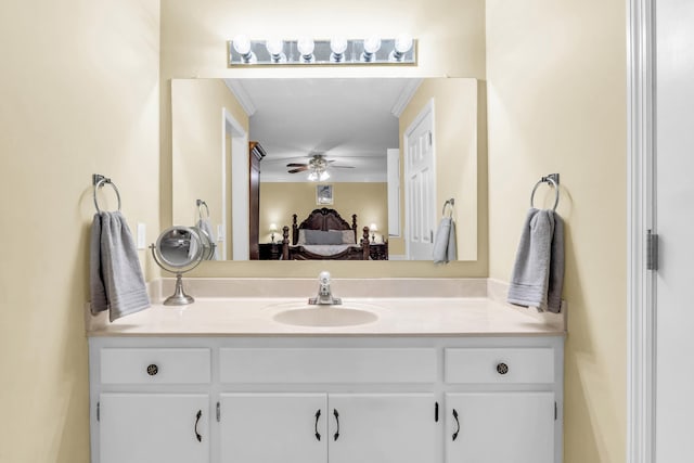 ensuite bathroom with vanity, ceiling fan, ornamental molding, and connected bathroom
