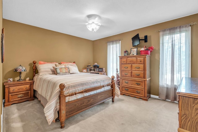 bedroom featuring light colored carpet and baseboards