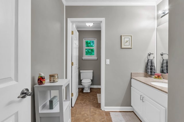 bathroom featuring tile patterned flooring, vanity, toilet, baseboards, and ornamental molding