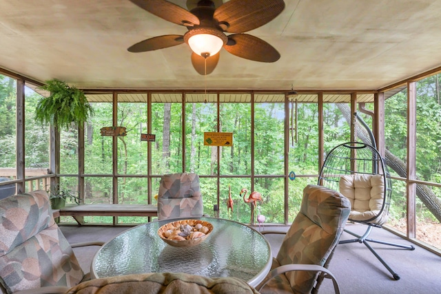 sunroom with carpet floors and ceiling fan