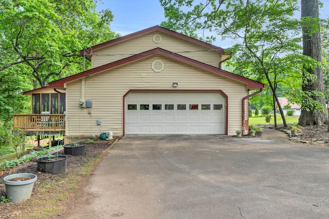 exterior space with a sunroom and aphalt driveway