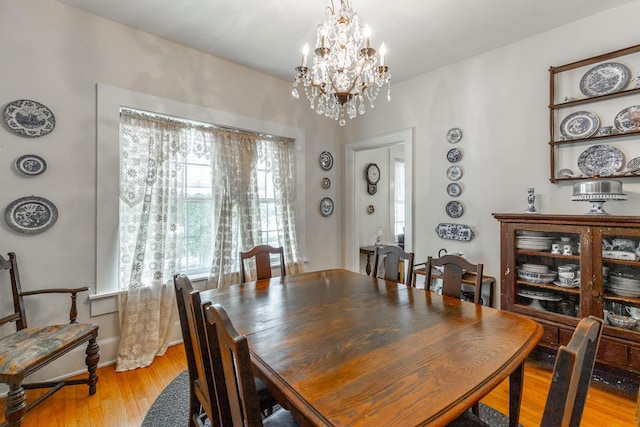 204 Lee-Gordon Mill Rd, Chickamauga, GA 30707 - dining space with light wood-style floors, a chandelier, and baseboards