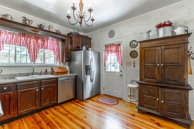 204 Lee-Gordon Mill Rd, Chickamauga, GA 30707 - kitchen with appliances with stainless steel finishes, a sink, light wood-type flooring, a chandelier, and wooden walls