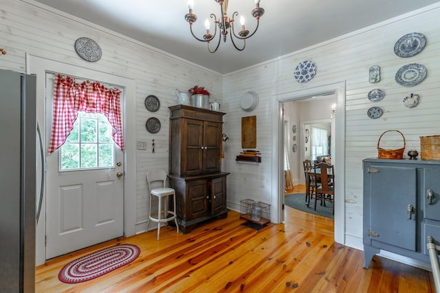 204 Lee-Gordon Mill Rd, Chickamauga, GA 30707 - entrance foyer featuring light wood-type flooring, a chandelier, and wood walls