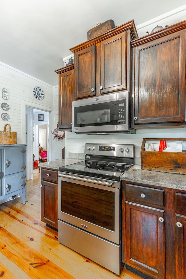 204 Lee-Gordon Mill Rd, Chickamauga, GA 30707 - kitchen with appliances with stainless steel finishes, light wood-style floors, dark brown cabinets, and stone counters
