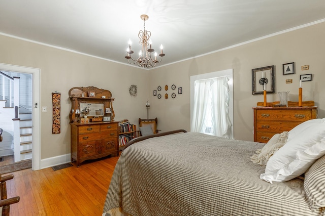 204 Lee-Gordon Mill Rd, Chickamauga, GA 30707 - bedroom featuring a chandelier, ornamental molding, light wood-style floors, multiple windows, and baseboards