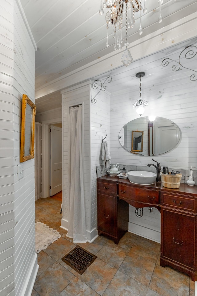 204 Lee-Gordon Mill Rd, Chickamauga, GA 30707 - full bathroom with wood walls, vanity, and a chandelier