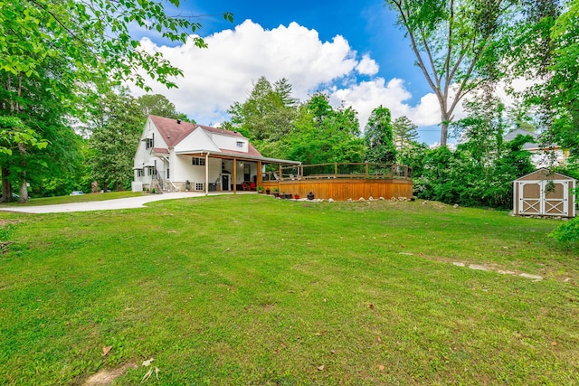 204 Lee-Gordon Mill Rd, Chickamauga, GA 30707 - view of green lawn with a storage shed, an outdoor structure, a deck, and view of wooded area