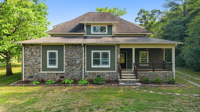 view of front facade featuring a shingled roof, a porch, a front lawn, and stone siding