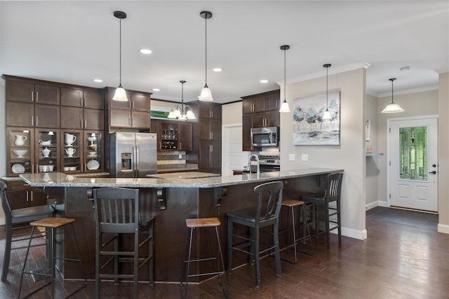 kitchen with decorative backsplash, dark brown cabinetry, baseboards, stainless steel appliances, and dark wood-type flooring