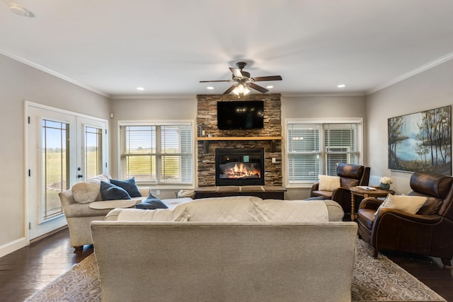 living area with a fireplace, ceiling fan, french doors, and dark wood-type flooring