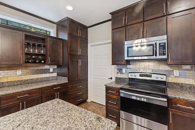 kitchen featuring light stone counters, tasteful backsplash, stainless steel appliances, and dark brown cabinets