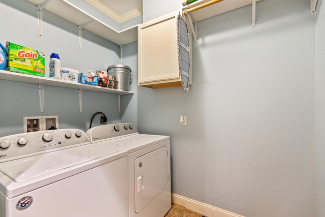 laundry area with baseboards, cabinet space, and washer and dryer