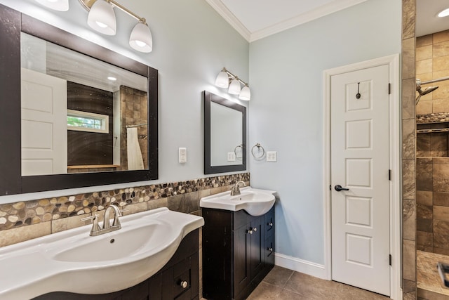 full bathroom with crown molding, tiled shower, two vanities, and a sink