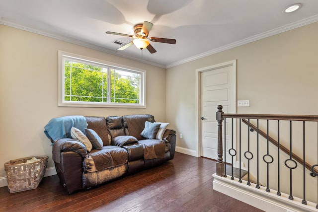 living room featuring a ceiling fan, visible vents, baseboards, ornamental molding, and dark wood-type flooring