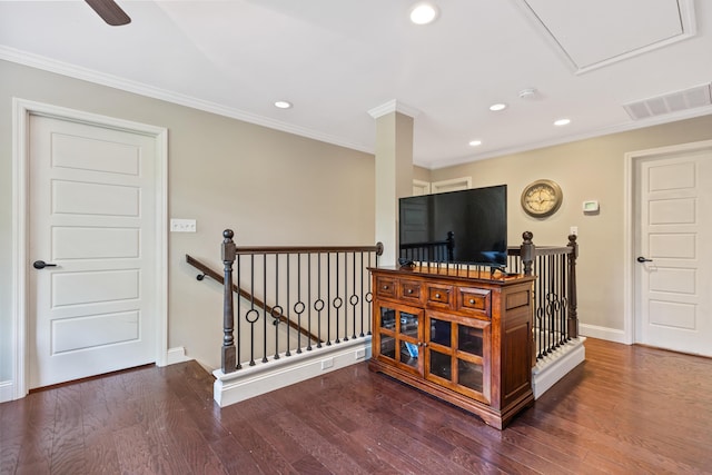 stairway with crown molding, recessed lighting, baseboards, wood finished floors, and visible vents