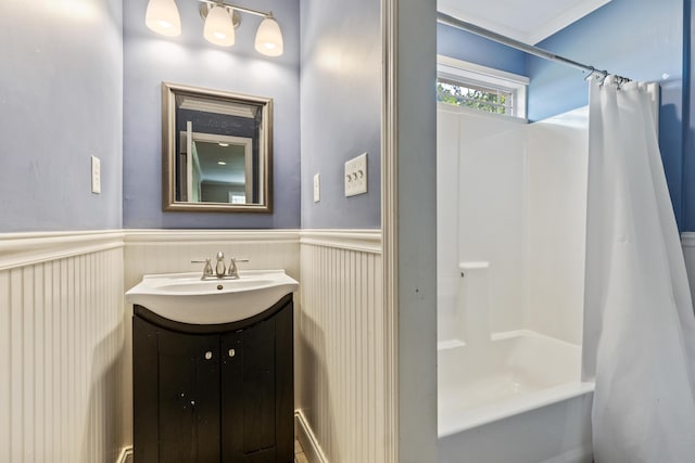 bathroom with wainscoting, shower / bath combo, and vanity