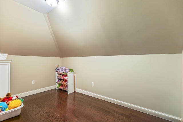 rec room with baseboards, dark wood-style floors, and lofted ceiling